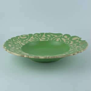 A rimmed plate adorned with calligraphy cut edges. Designed for presenting dishes or serving pasta.