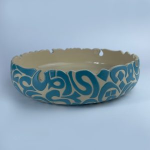 A curved rim bowl adorned with calligraphy cut edges