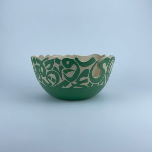 A  U-shaped bowl adorned with calligraphy cut edges. Ideal for serving and display.