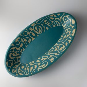 A tapered oval plate flowing calligraphic forms. Suitable for serving food