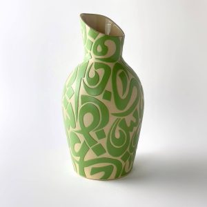 A  handleless carafe featuring calligraphic forms for serving water