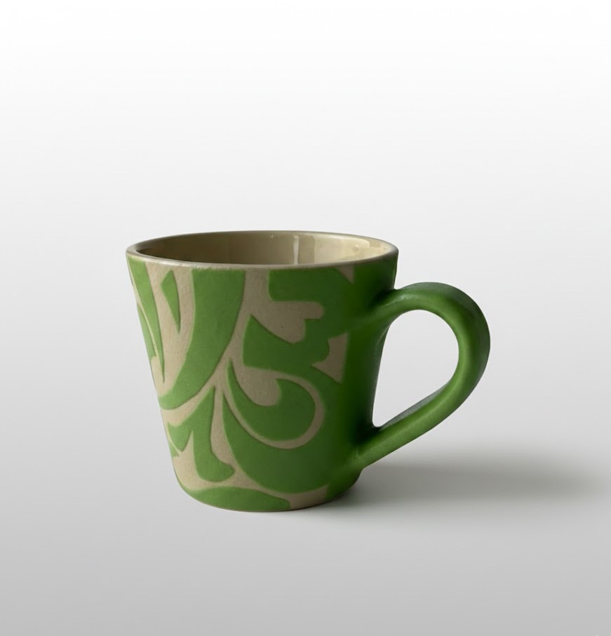 A V-shaped mug featuring calligraphic motifs