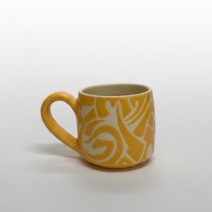 An edged mug featuring calligraphic motifs
