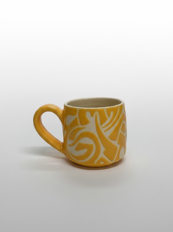 An edged mug featuring calligraphic motifs