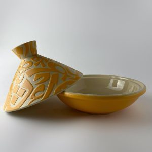 A tajine with a conical lid featuring flowing Arabic calligraphy