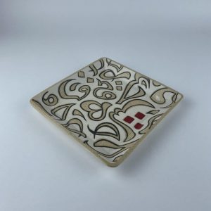 A square plate featuring calligraphy motifs