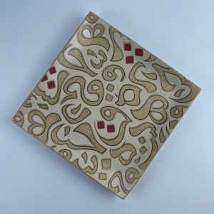 A square plate featuring contrasting calligraphy motifs