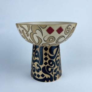 An elevated bowl with contrasting calligraphy