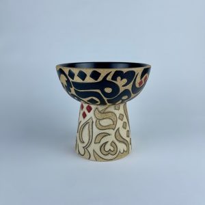 An elevated bowl with contrasting calligraphy