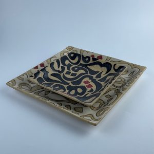 A set of two rectangular appetizer trays with contrasting calligraphy motifs