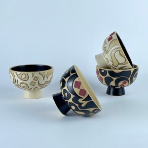 A pedestal nut bowls set featuring a calligraphy forms