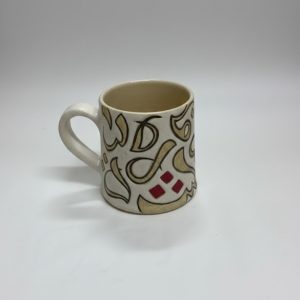 A mug featuring calligraphic motifs