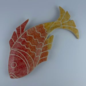 A hand-built fish-shaped plate finished with an ombré effect