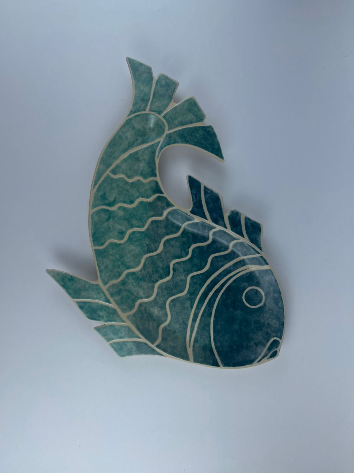 A hand-built fish-shaped plate finished with an ombré effect