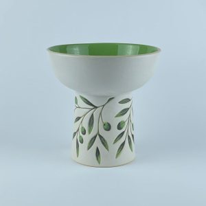 An elevated bowl featuring delicate olive branch and leaf motifs