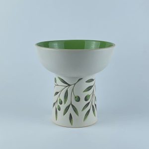 An elevated bowl featuring delicate olive branch and leaf motifs