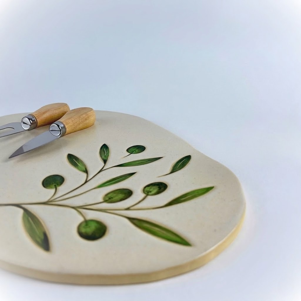 featuring delicate olive branch and leaf motifs. Designed for serving cheese on special occasions.