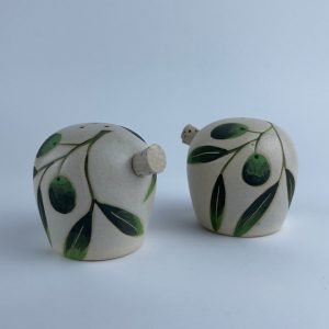 A set of two salt and pepper shakers adorned with delicate olive branch and leaf motifs