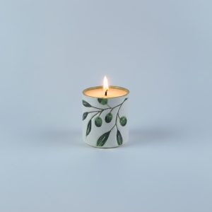 with a glossy green interior filled with wax. Designed to create a warm