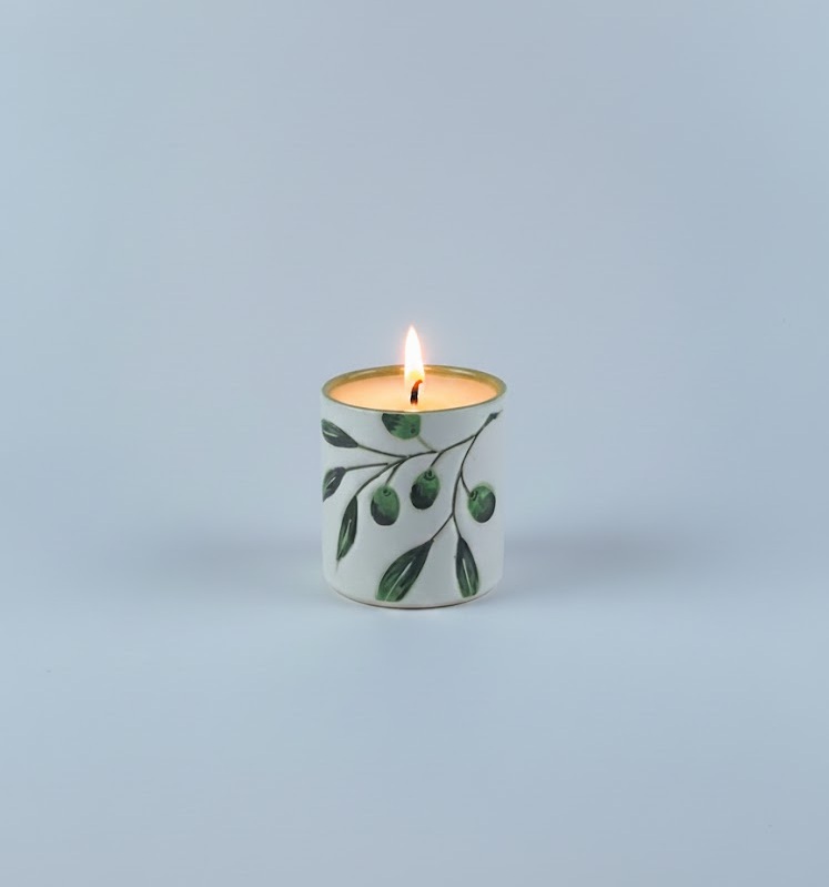 with a glossy green interior filled with wax. Designed to create a warm