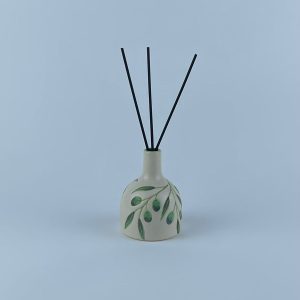A jar-shaped reed diffuser featuring delicate olive branch and leaf motifs. Designed to gently scent your space.