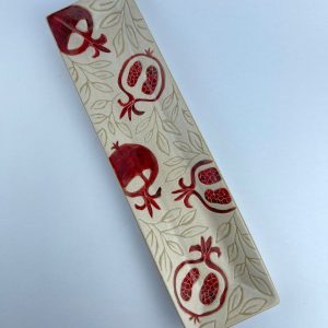 A rectangular appetizer tray featuring pomegranate motifs