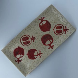 A rectangular platter featuring pomegranate motifs