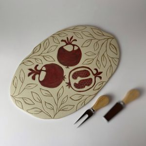 A hand-built organic cheese platter with a serving set
