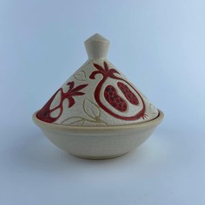 A small tajine with a conical lid and wide base. The lid features red pomegranate motifs
