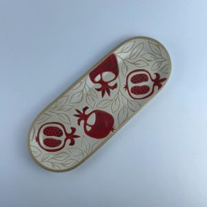 A wide-front oval plate featuring red pomegranate motifs. Suitable for serving appetizers
