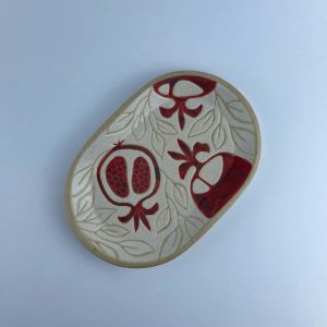 A wide-front oval plate featuring red pomegranate motifs. Suitable for serving appetizers