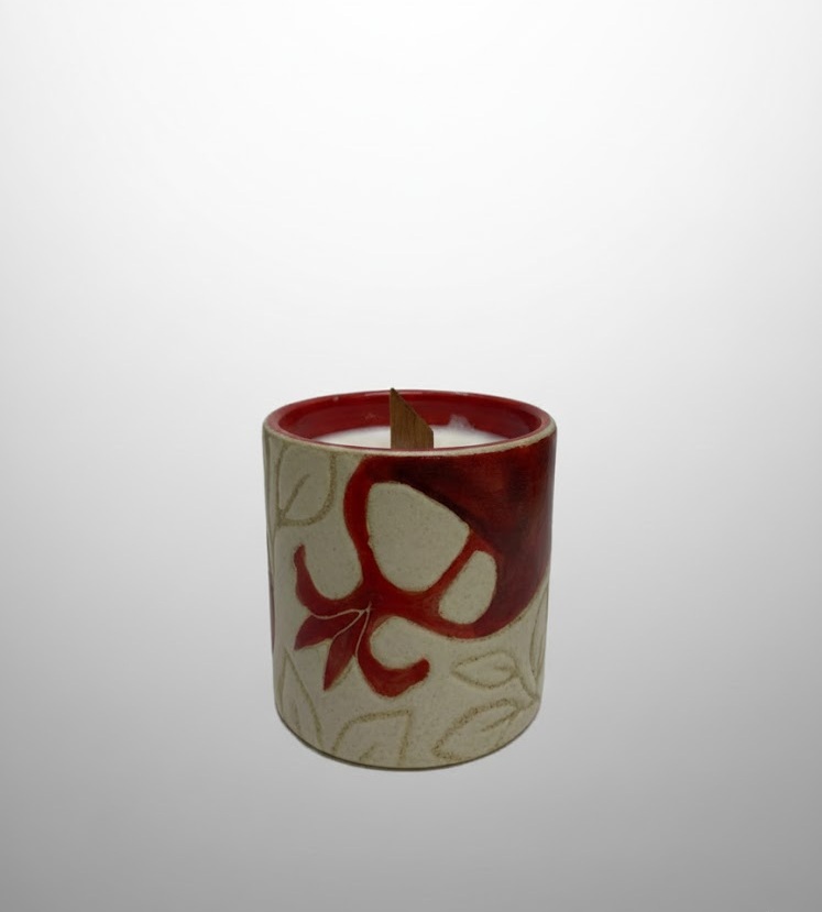 A cylindrical candle vessel featuring pomegranate motifs with a glossy red interior. Designed for poured candle wax.