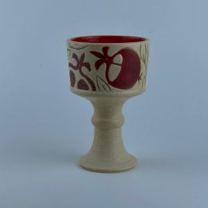 A goblet-shaped incense burner adorned with pomegranate motifs and a glossy red interior. Designed for incense burning and display.