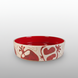 A cylindrical bowl featuring a red interior and red pomegranate motifs. Suitable for serving food or salad