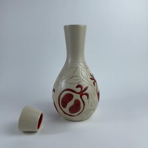 A handleless lidded Qarura (carafe) featuring a red pomegranate motifs